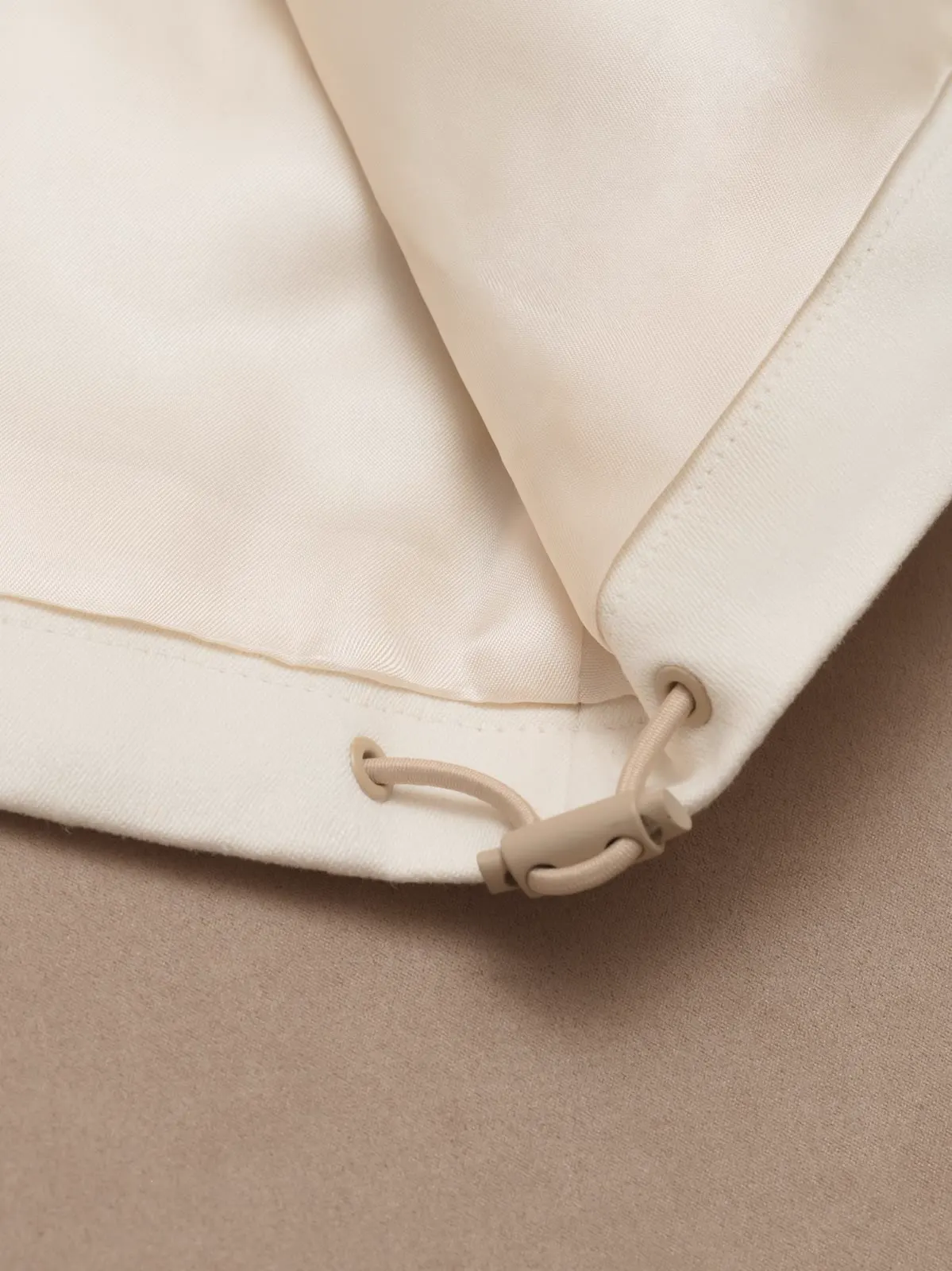 Close-up of the hem with a drawcord and a toggle