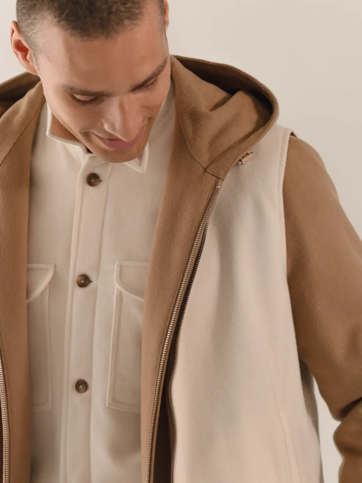 Light overshirt with buttons under a brown hooded gilet