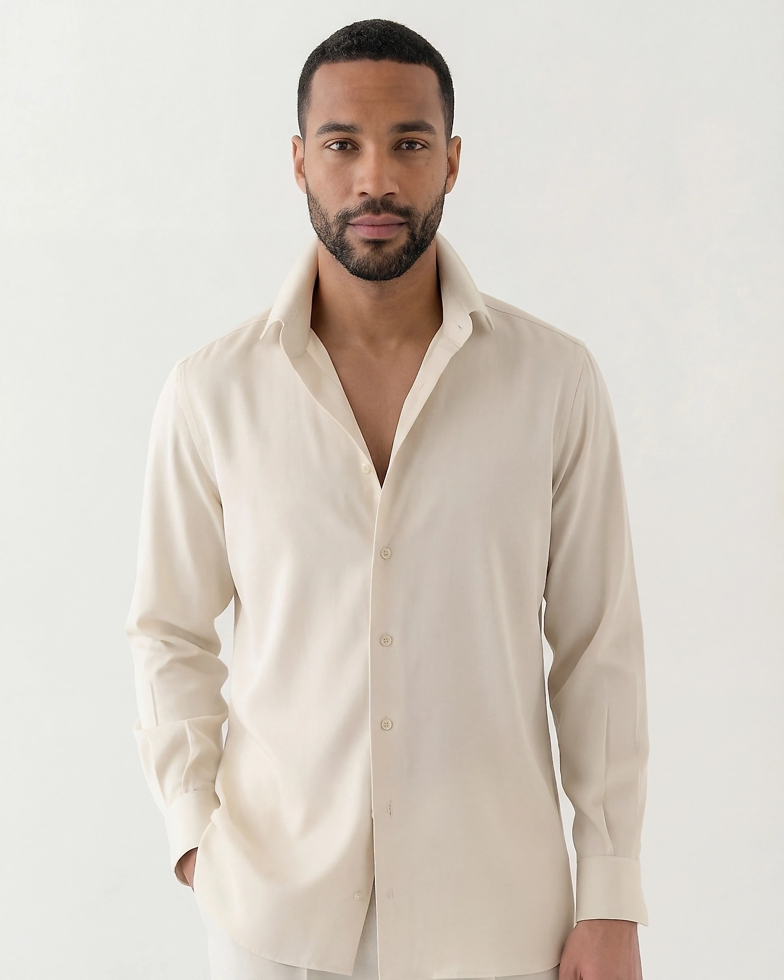 Man in a smooth, light off-white shirt with an open collar
