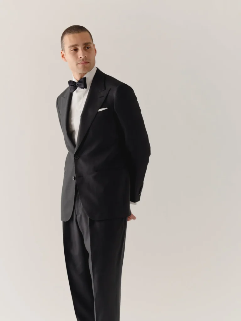 Man in formal black suit and bowtie.